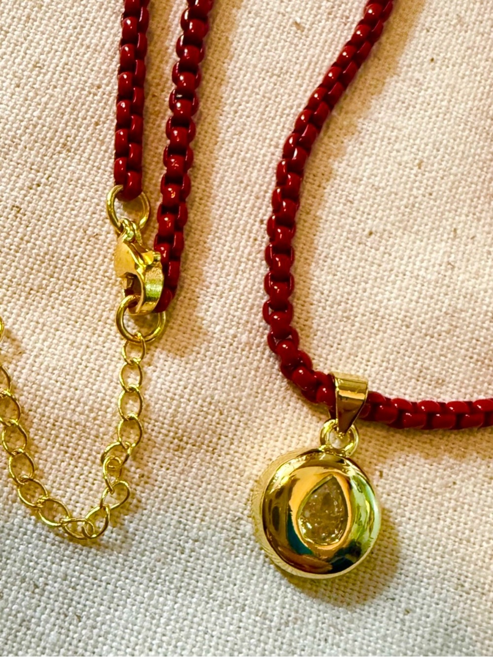 crystal bezel on enamel red chain, 14kt gold plated